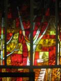 Fall season in stained glass along the chapel wall.